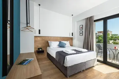 a bedroom with a large bed and a balcony at The Meta Stay -Rooftop Access Sunny 2bdr Apartment in Athens