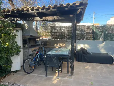 a bike parked under a pergola with a table at Апартаменты в Вари in Vari