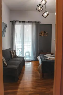 a living room with a couch and a bed at 50 Steps Apart Metro Neos Kosmos in Athens