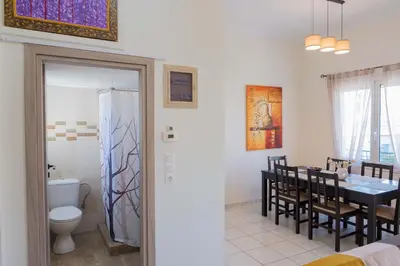 a kitchen and dining room with a table and a dining room at Cozy Greek Apartment in Athens