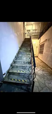 a staircase in a building with a metal railing at Cozy Greek Apartment in Athens