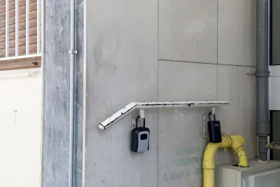 a yellow pipe on the wall of a building at Pagrati Cozy Retreat in Athens