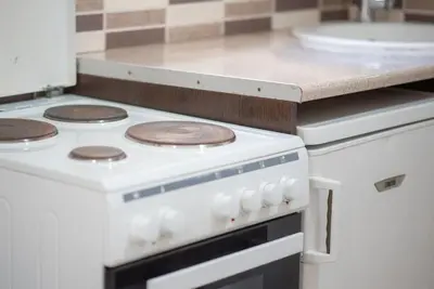 a white stove top oven in a kitchen at Pagrati Cozy Retreat in Athens