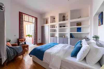 a bedroom with a large bed with white shelves at Spacious 2-Bdrm Apt at Filopappou hill in Koukaki! in Athens