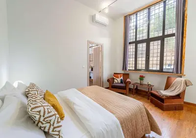 a bedroom with a bed and a large window at Spacious 2-Bdrm Apt at Filopappou hill in Koukaki! in Athens