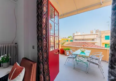 a room with a balcony with a table and chairs at Spacious 2-Bdrm Apt at Filopappou hill in Koukaki! in Athens