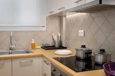 a kitchen with a stove and a sink at Cosy Athens Downtown Apartment in Athens