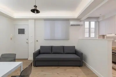 a living room with a couch in a room at Cosy Athens Downtown Apartment in Athens