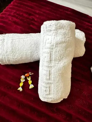a roll of white sock on a bed at NEW Boutique Athens HEART Kypseli in Athens