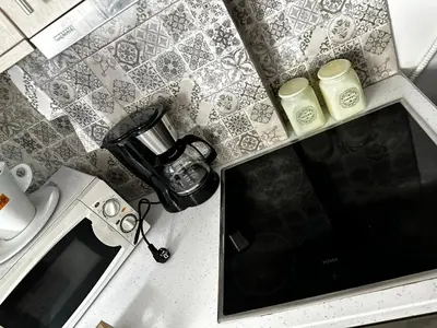 a kitchen counter with a counter top with a stove and a counter top at NEW Boutique Athens HEART Kypseli in Athens