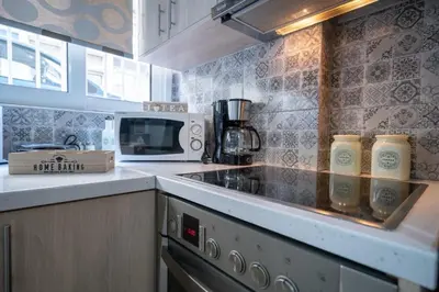 a kitchen with a stove and a microwave at NEW Boutique Athens HEART Kypseli in Athens