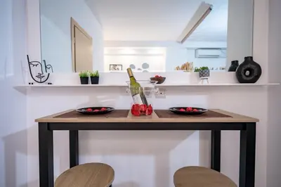 a table with a bottle of wine on it in a kitchen at NEW Boutique Athens HEART Kypseli in Athens
