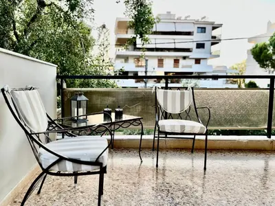 two chairs and a table on a balcony at Elaia Luxury Selections - Emerald in Athens