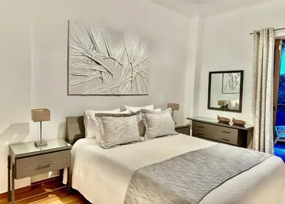 a bedroom with a bed and a painting on the wall at Elaia Luxury Selections - Emerald in Athens