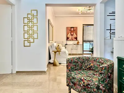 a living room with a couch and a chair at Elaia Luxury Selections - Emerald in Athens