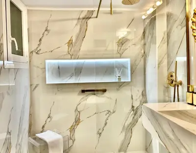 a bathroom with white marble walls and a sink at Elaia Luxury Selections - Emerald in Athens