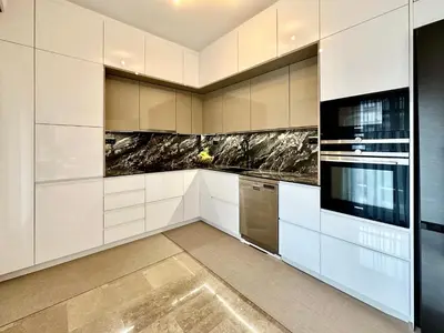 a kitchen with white cabinets and stainless steel appliances at Elaia Luxury Selections - Emerald in Athens
