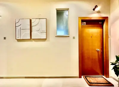 a hallway with a wooden door and a window at Elaia Luxury Selections - Emerald in Athens