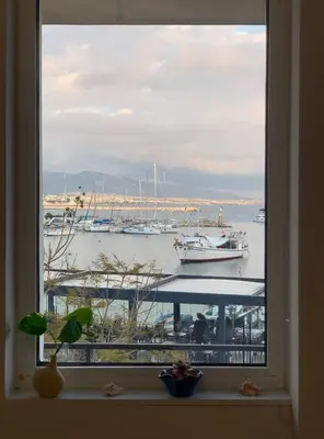 a window with a view of a marina with boats at Zefi's Loft - Sea View in Piraeus in Piraeus