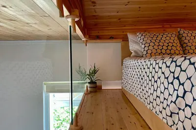 a bedroom with a bed and a glass table at Zefi's Loft - Sea View in Piraeus in Piraeus