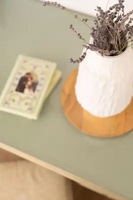 a white cake on a table next to a book at Modern apartment at Edem beach in Athens