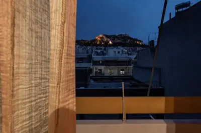 a view from a window of a city at night at Lycabettus view Vintage penthouse flat in Exarchia in Athens
