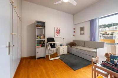 a living room with a couch and a table at Lycabettus view Vintage penthouse flat in Exarchia in Athens