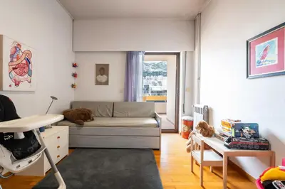a living room with a dog laying on a bed at Lycabettus view Vintage penthouse flat in Exarchia in Athens