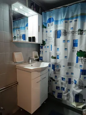 a bathroom with a sink and a shower curtain at Exarcheia cozy nest in Athens