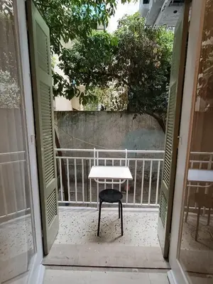 an open door with a bench sitting on a porch at Exarcheia cozy nest in Athens