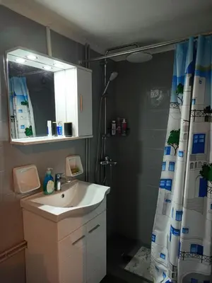 a bathroom with a shower curtain and a sink at Exarcheia cozy nest in Athens