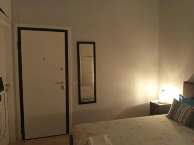 a bedroom with a bed and a mirror on the wall at Exarcheia cozy nest in Athens