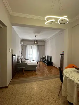 a living room with a couch and a table at Frinis House in Athens