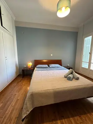 a bedroom with a large bed with two pillows on it at Frinis House in Athens