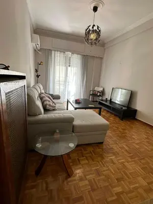 a living room with a couch and a table at Frinis House in Athens
