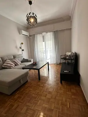 a living room with a couch and a table at Frinis House in Athens
