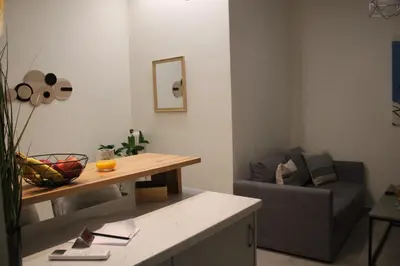 a living room with a table and a couch at ARIS central Ampelokipoi in Athens