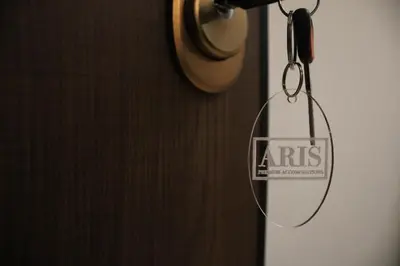 a sign is hanging on a door with a chain at ARIS central Ampelokipoi in Athens