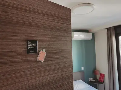 a door in a hotel room with a cell phone on it at Have a Rest Netflix, Nespresso in Athens