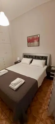 a bedroom with a large bed with towels on it at Styl Apartment in Athens