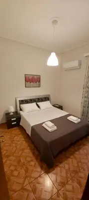 a bedroom with a large bed with two towels on it at Styl Apartment in Athens