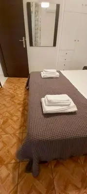 a bed with two white napkins on top of it at Styl Apartment in Athens