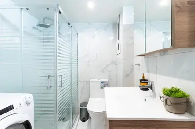 a bathroom with a toilet and a glass shower at AIOLOS centre plateia nea smyrni in Athens