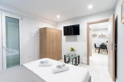 a bedroom with a bed and a sliding glass door at AIOLOS centre plateia nea smyrni in Athens