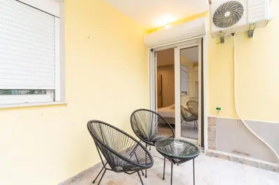 a room with two chairs and a mirror at AIOLOS centre plateia nea smyrni in Athens