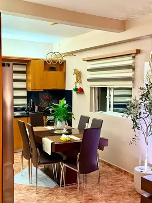 a kitchen and dining room with a table and chairs at luxury house airport in Koropíon