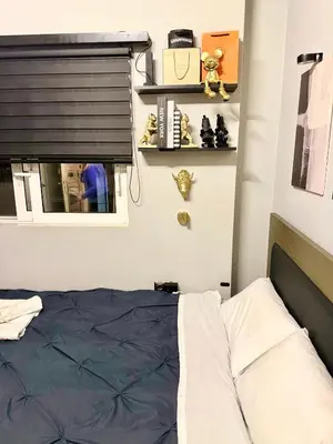 a bedroom with a bed and a window and shelves at luxury house airport in Koropíon