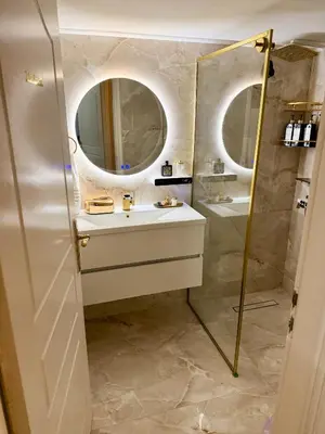 a bathroom with a sink and a shower with a mirror at luxury house airport in Koropíon