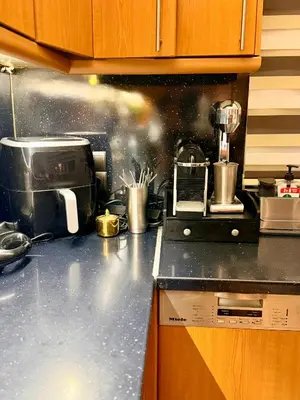 a kitchen counter top with a toaster and a microwave at luxury house airport in Koropíon