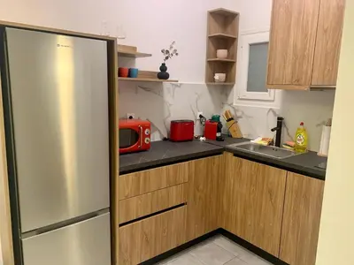 a kitchen with a stainless steel refrigerator and a microwave at Koukaki Gem Chic Apt near Acropolis in Athens